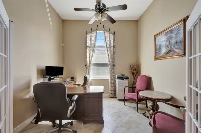 a view of a workspace with furniture and a window