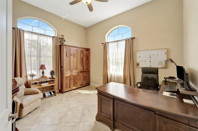 a view of a workspace with furniture and a window