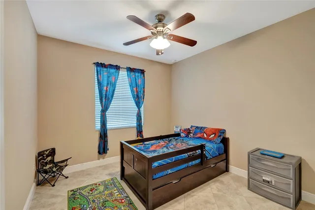 a living room with furniture and a baby crib