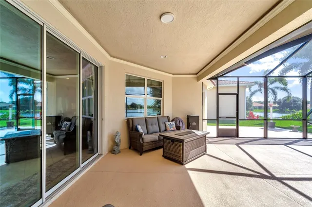 a living room with furniture and a floor to ceiling window