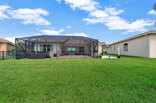a view of a house with a backyard