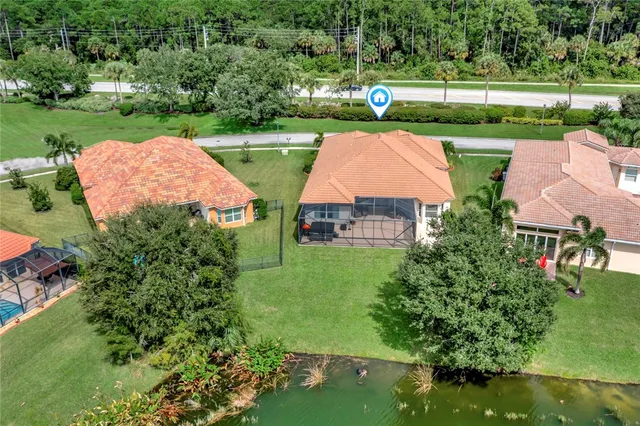 an aerial view of a house with outdoor space swimming pool and green space