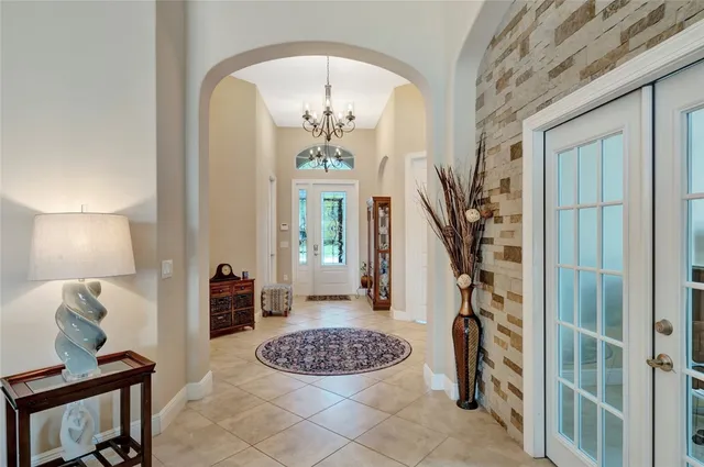 a view of a hallway with wooden floor and a dining room view