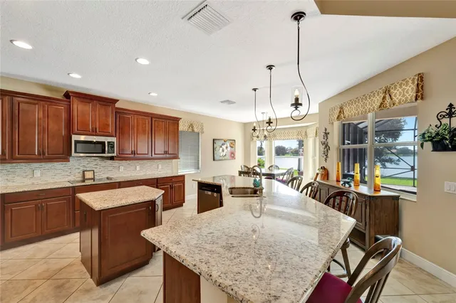 a kitchen with stainless steel appliances granite countertop stove top oven and cabinets