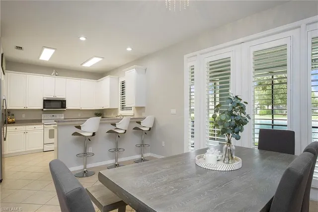 a open dining room with kitchen island furniture a chandelier and kitchen view