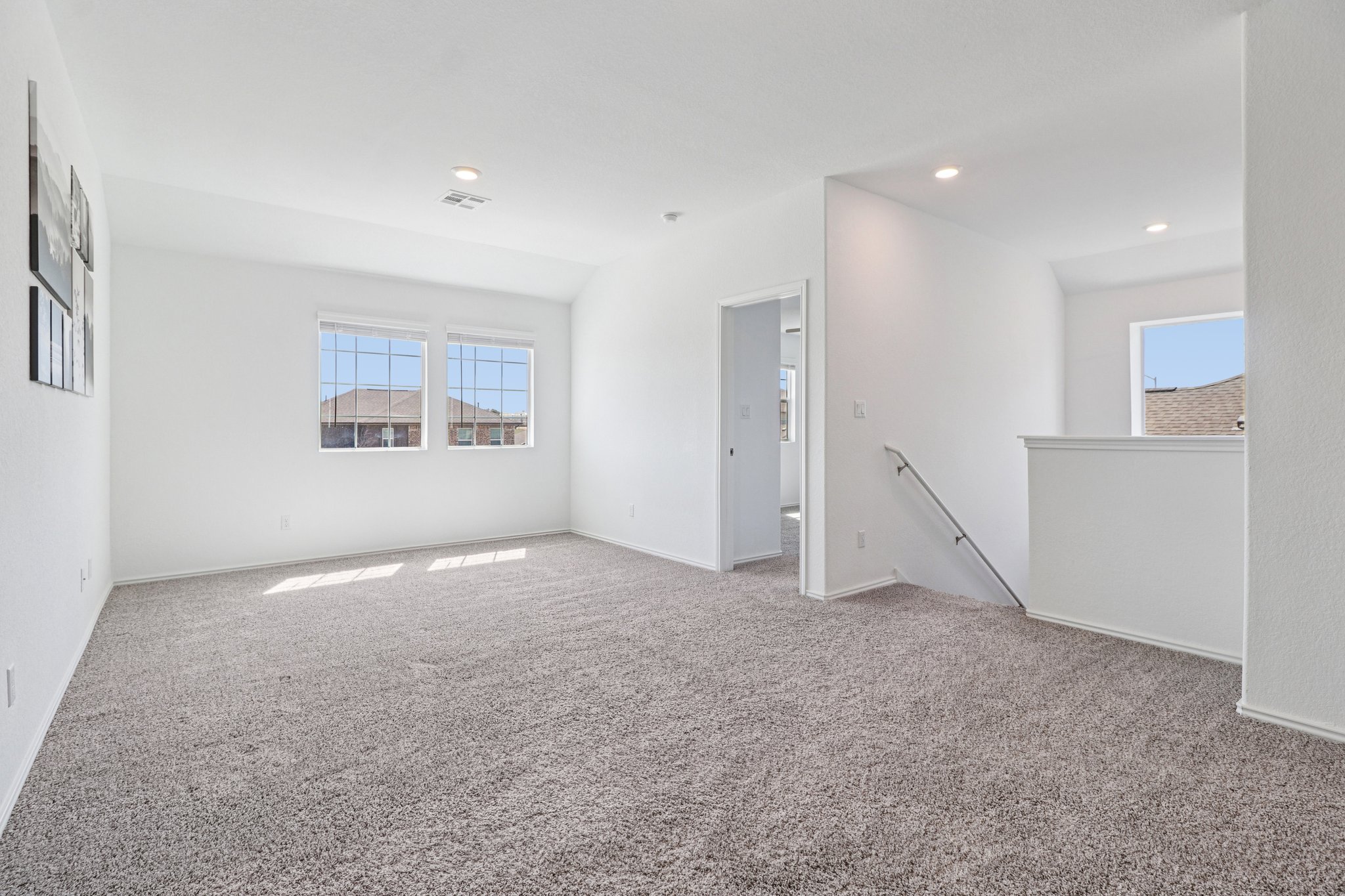1201 Mallow Road Leander, TX 78641 - Photo 24 of 40 Empty room with light colored carpet, plenty of natural light, and recessed lighting