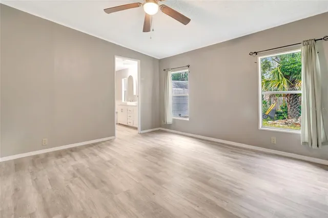 an empty room with windows and closet