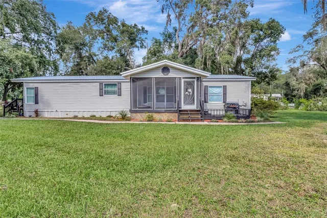 a front view of house with yard and green space