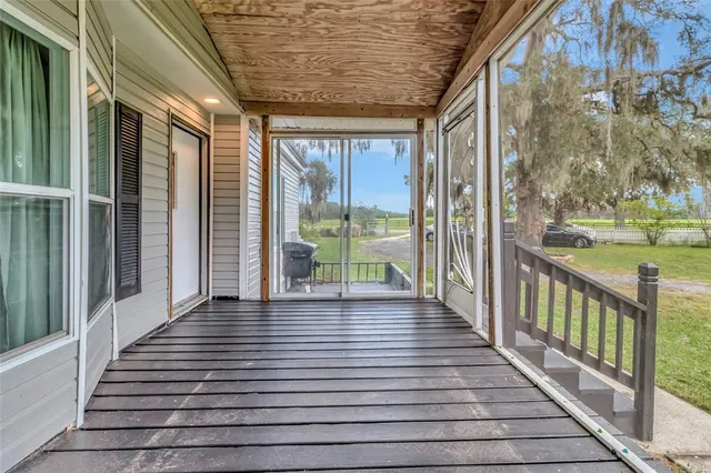 a view of a porch with wooden floor and outdoor space