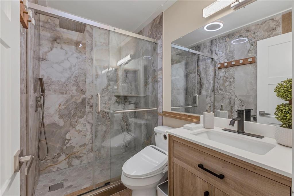 5611 Summerside Lane, Unit 46B Sarasota, FL 34231 - Photo 22 of 31 a bathroom with a sink toilet and shower