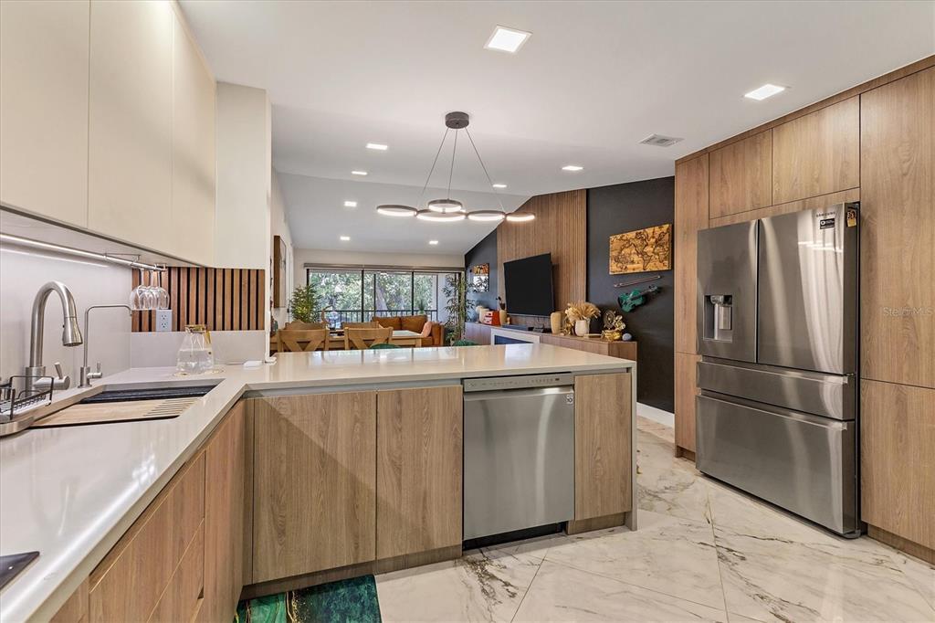 5611 Summerside Lane, Unit 46B Sarasota, FL 34231 - Photo 8 of 31 a kitchen with stainless steel appliances granite countertop a refrigerator a sink and a stove