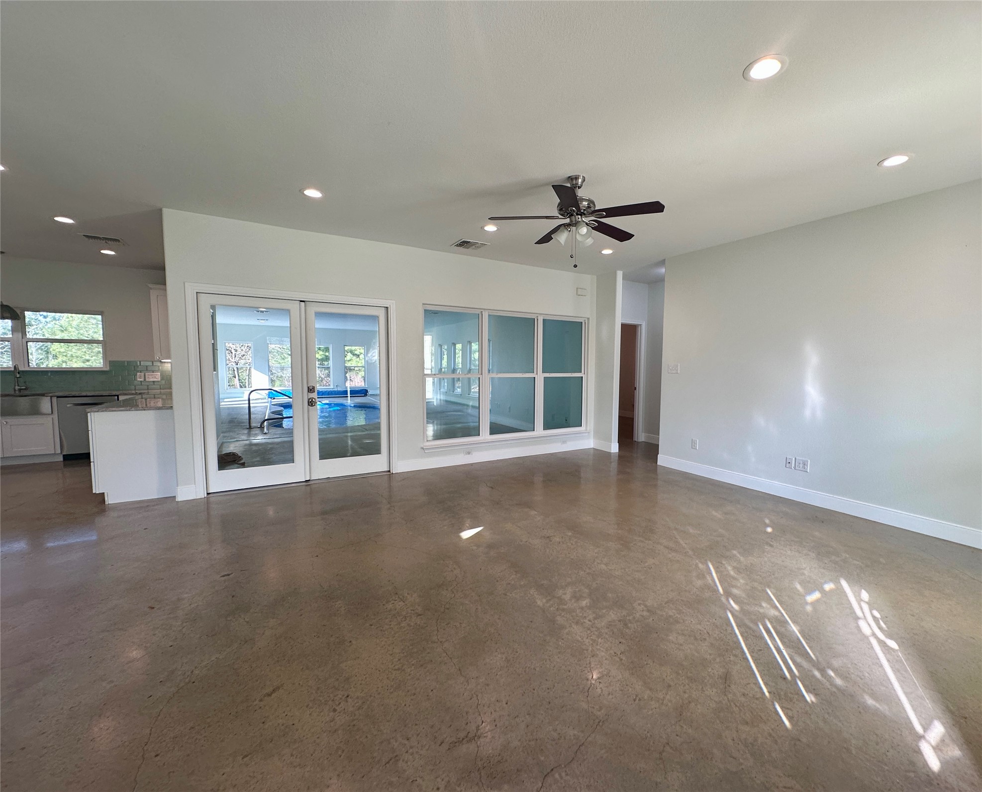 124 Pine Path Bastrop, TX 78602 - Photo 7 of 31 living room with french doors to pool room, recessed lighting, ceiling fan, and open concept