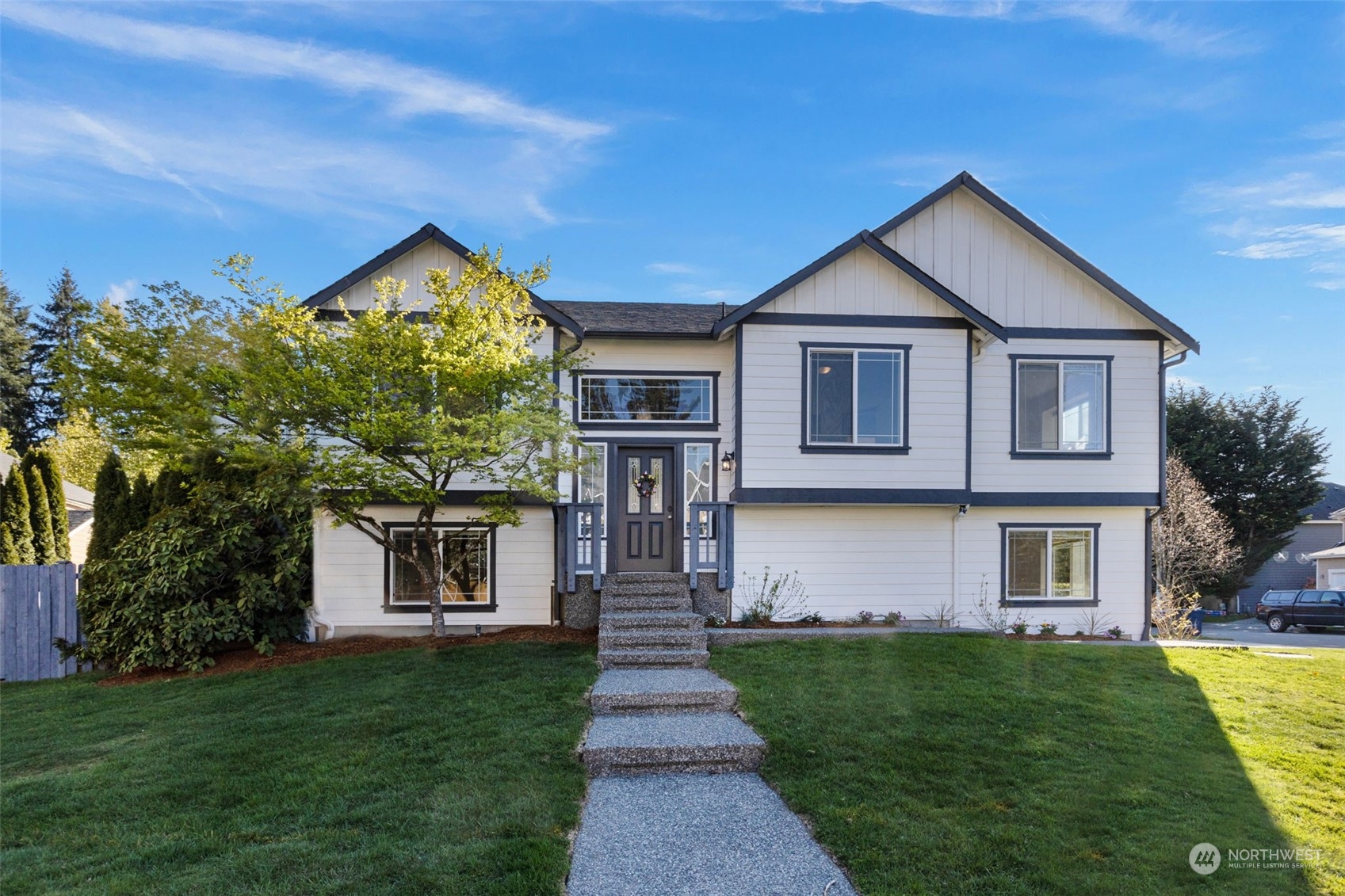 15317 Sunset Road Bothell, WA 98012 - Photo 1 of 24 a front view of a house with a yard and garage