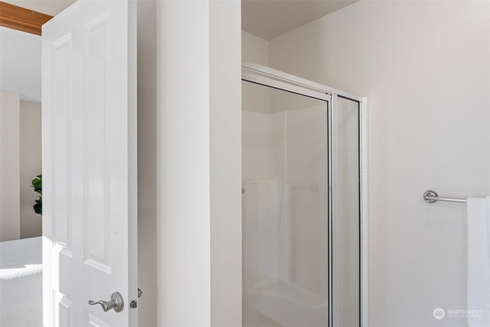 15317 Sunset Road Bothell, WA 98012 - Photo 15 of 24 a bathroom with a glass shower door
