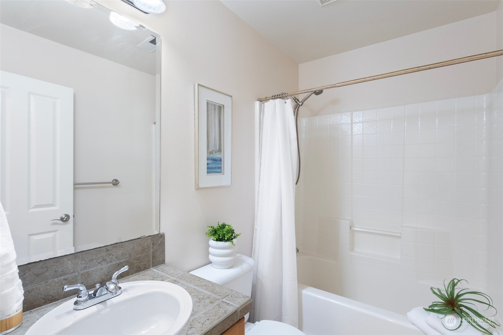 15317 Sunset Road Bothell, WA 98012 - Photo 21 of 24 a bath room with a sink and a mirror