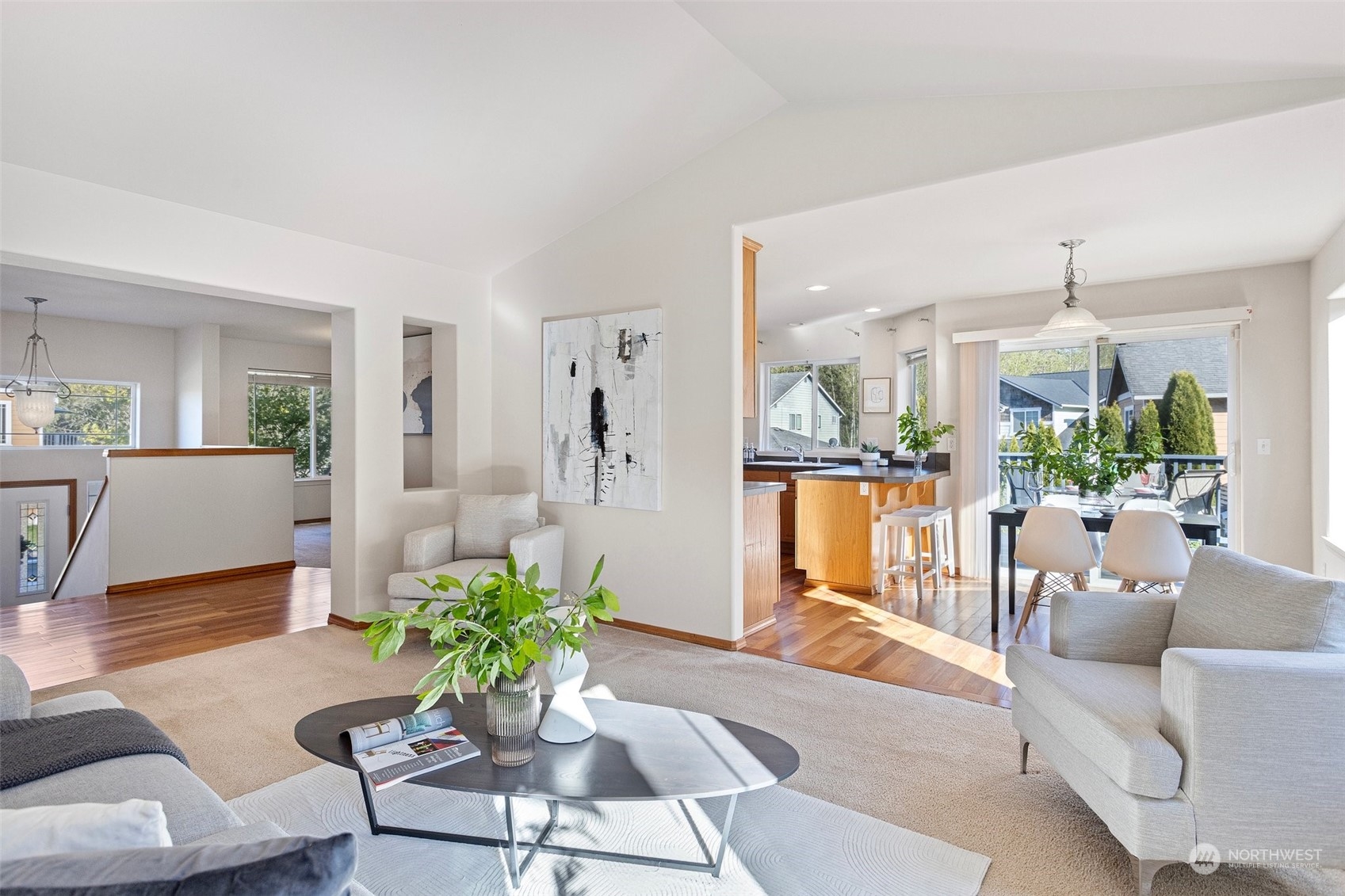 15317 Sunset Road Bothell, WA 98012 - Photo 4 of 24 a living room with furniture a chandelier and a dining table