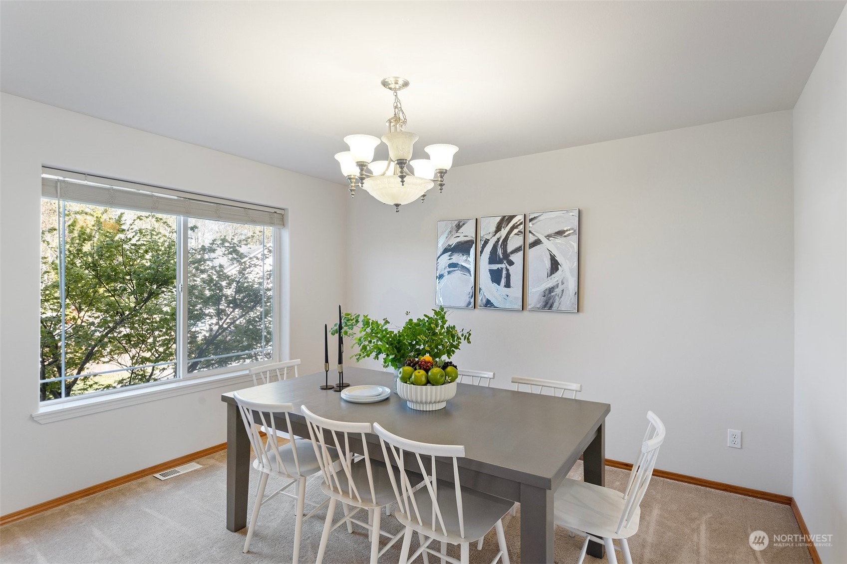 15317 Sunset Road Bothell, WA 98012 - Photo 8 of 24 a dining room with furniture a large window and wooden floor
