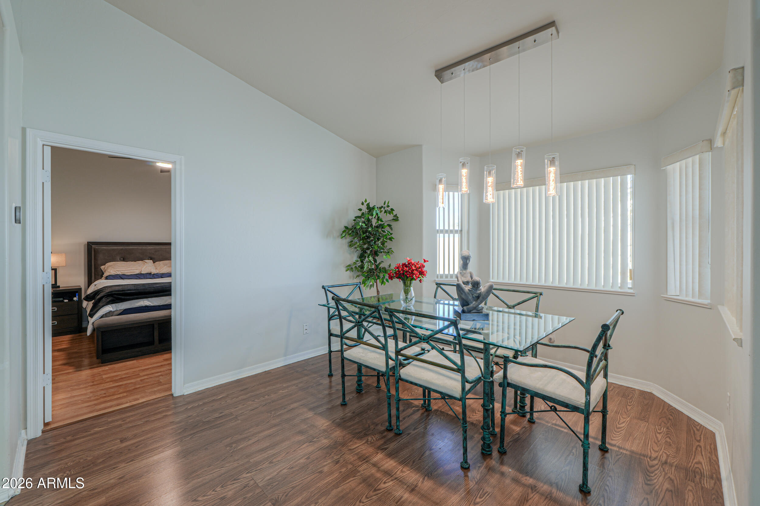5830 East McKellips Road, Unit 27 Mesa, AZ 85215 - Photo 17 of 47 a view of a dining room with furniture and wooden floor