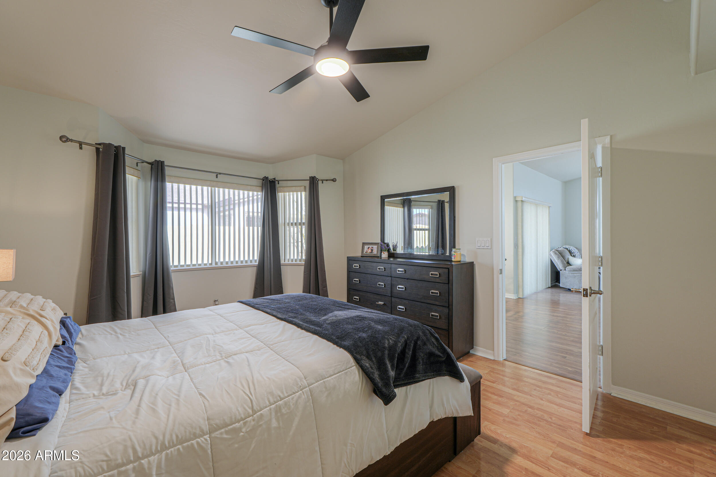 5830 East McKellips Road, Unit 27 Mesa, AZ 85215 - Photo 18 of 47 a bedroom with a large bed and a chandelier