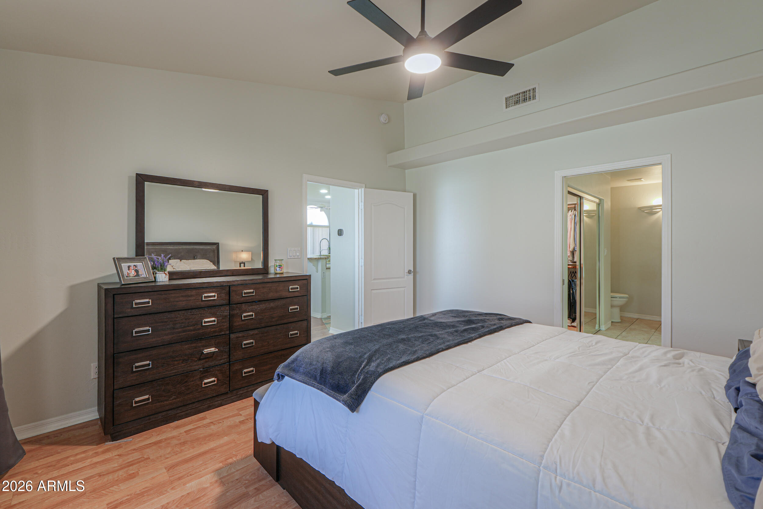 5830 East McKellips Road, Unit 27 Mesa, AZ 85215 - Photo 19 of 47 a bedroom with a bed and a mirror on dresser
