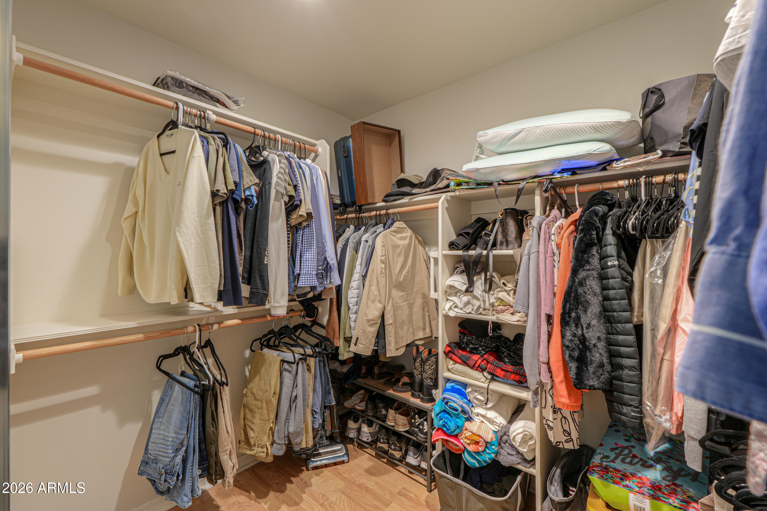 5830 East McKellips Road, Unit 27 Mesa, AZ 85215 - Photo 22 of 47 a view of walk in closet with clothes and shoes
