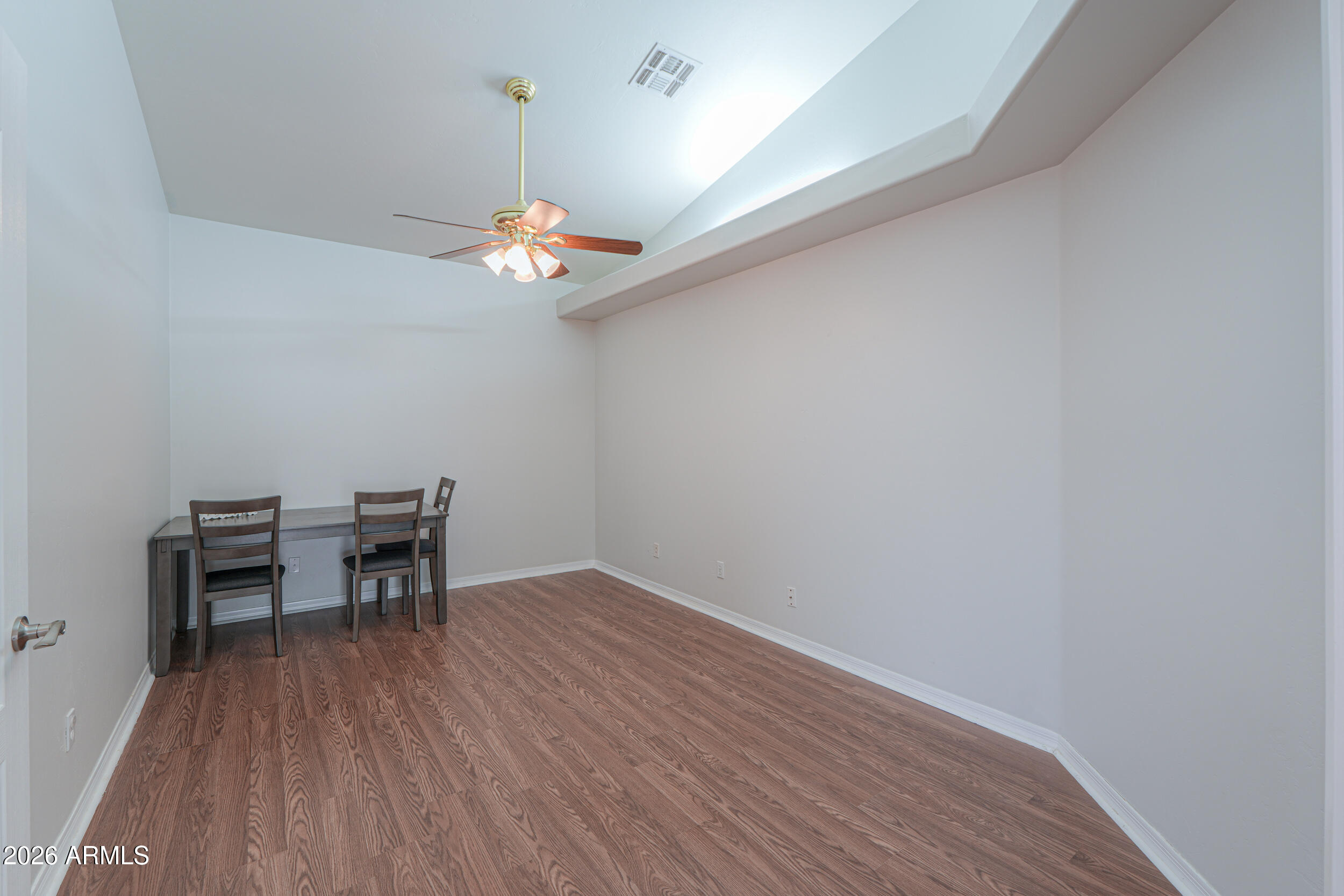 5830 East McKellips Road, Unit 27 Mesa, AZ 85215 - Photo 24 of 47 a view of a room with a wooden floor and a ceiling fan