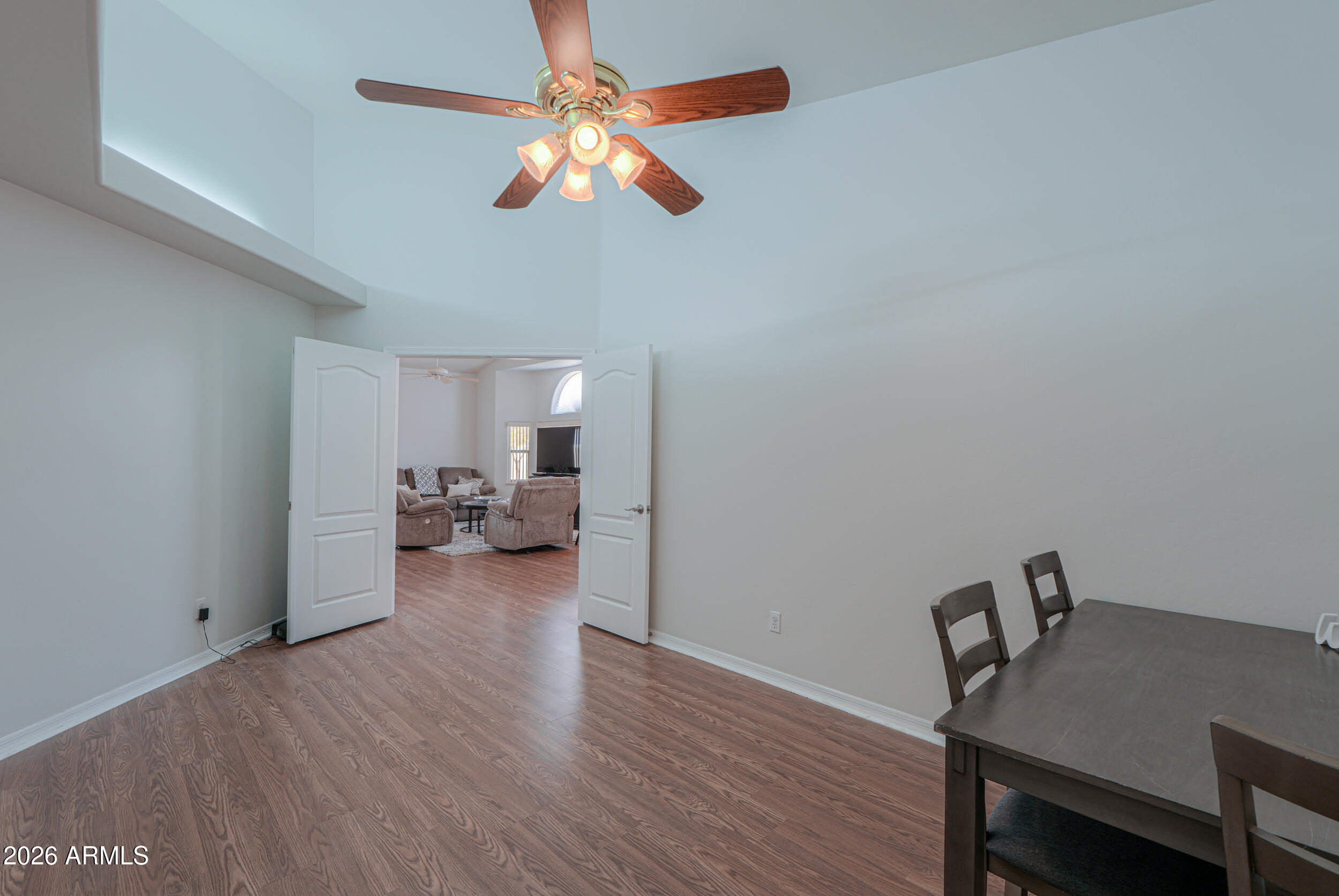 5830 East McKellips Road, Unit 27 Mesa, AZ 85215 - Photo 25 of 47 a living room with furniture and a chandelier