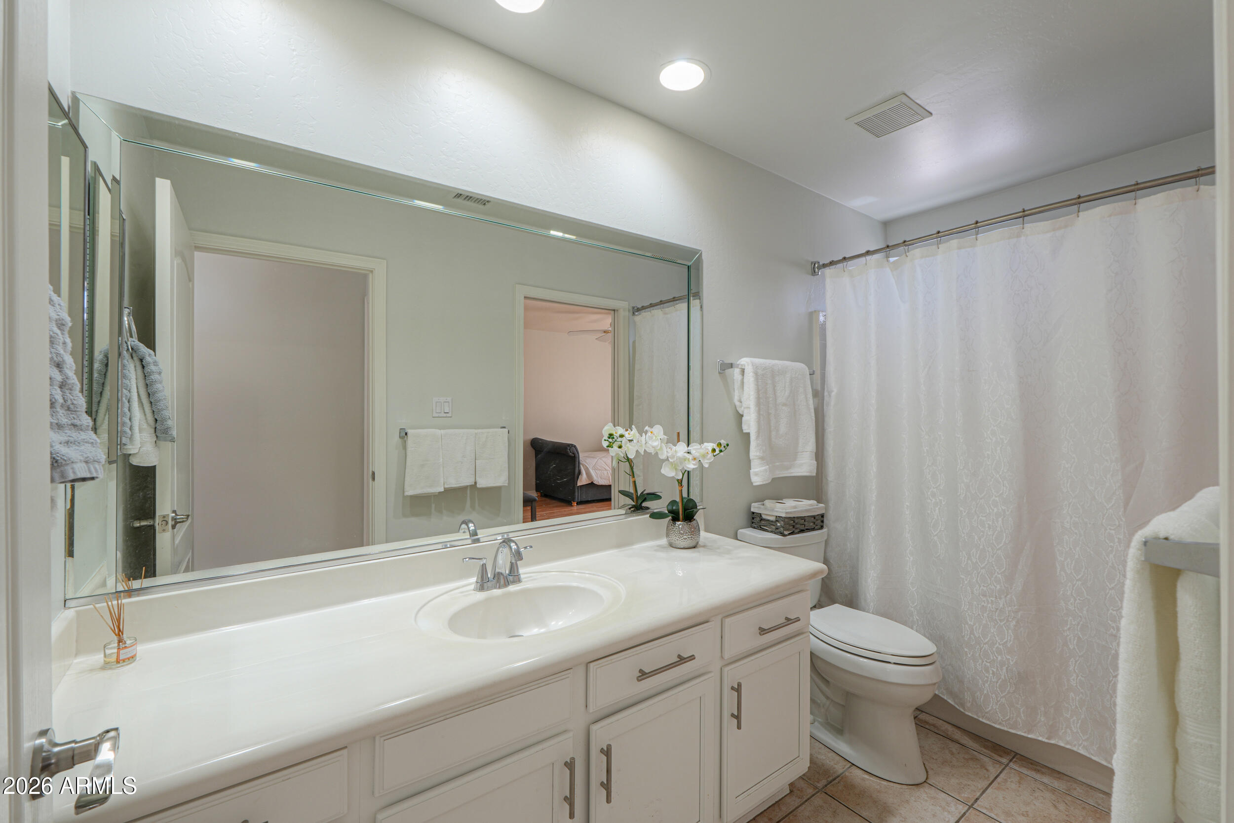5830 East McKellips Road, Unit 27 Mesa, AZ 85215 - Photo 29 of 47 a bathroom with a granite countertop sink toilet and mirror