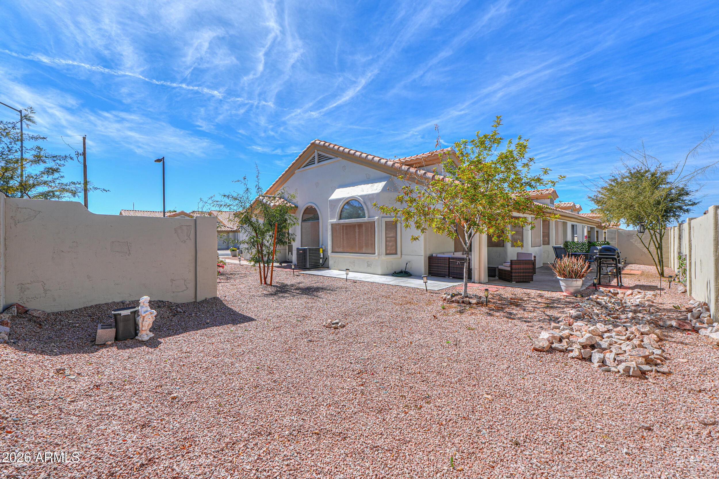 5830 East McKellips Road, Unit 27 Mesa, AZ 85215 - Photo 35 of 47 a view of a house with a patio and a yard