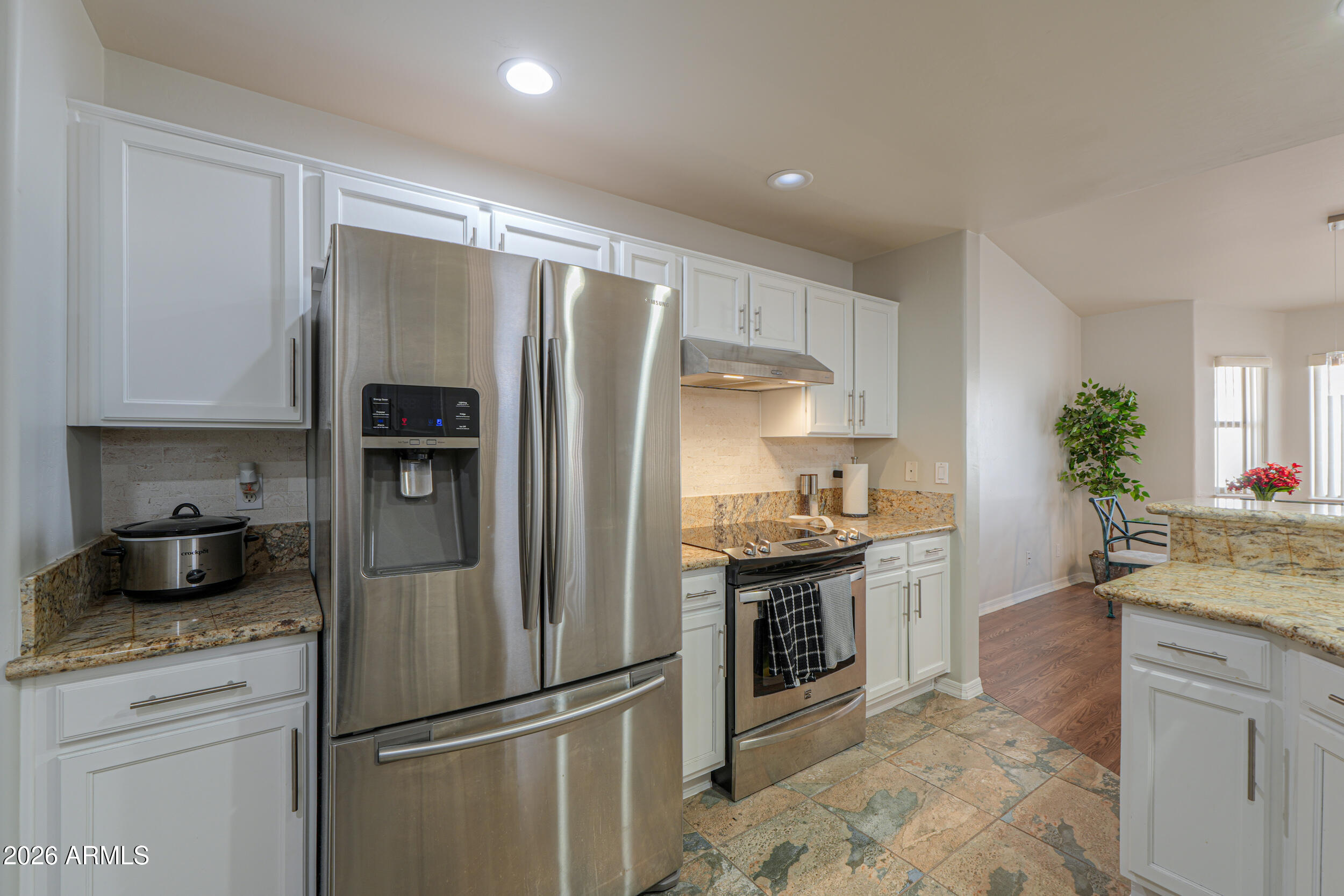 5830 East McKellips Road, Unit 27 Mesa, AZ 85215 - Photo 4 of 47 a kitchen with stainless steel appliances granite countertop a refrigerator a stove and a sink