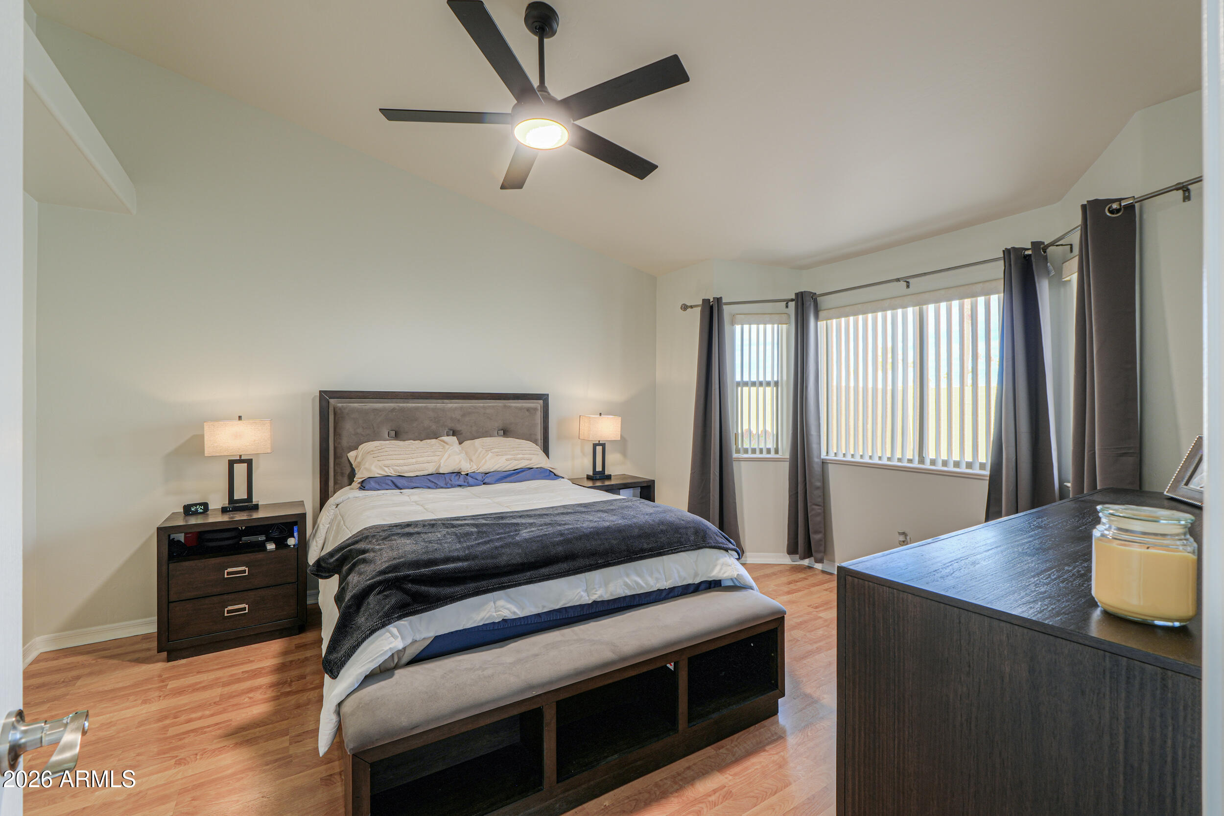 5830 East McKellips Road, Unit 27 Mesa, AZ 85215 - Photo 5 of 47 a bedroom with a bed and a chandelier