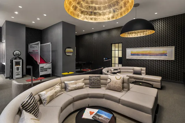 a living room with furniture and a lamp