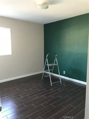 a view of a room with wooden floor and a sink