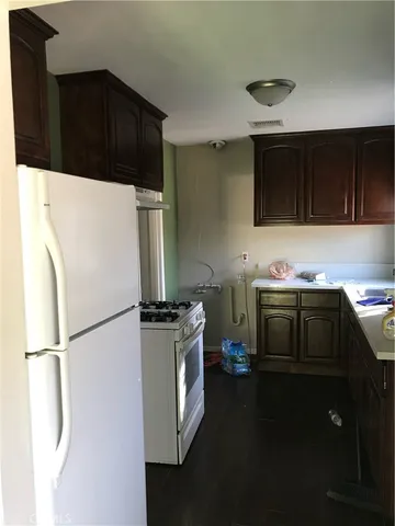 a kitchen with stainless steel appliances a stove a refrigerator and a microwave