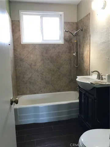 a bathroom with a sink a toilet and a bathtub