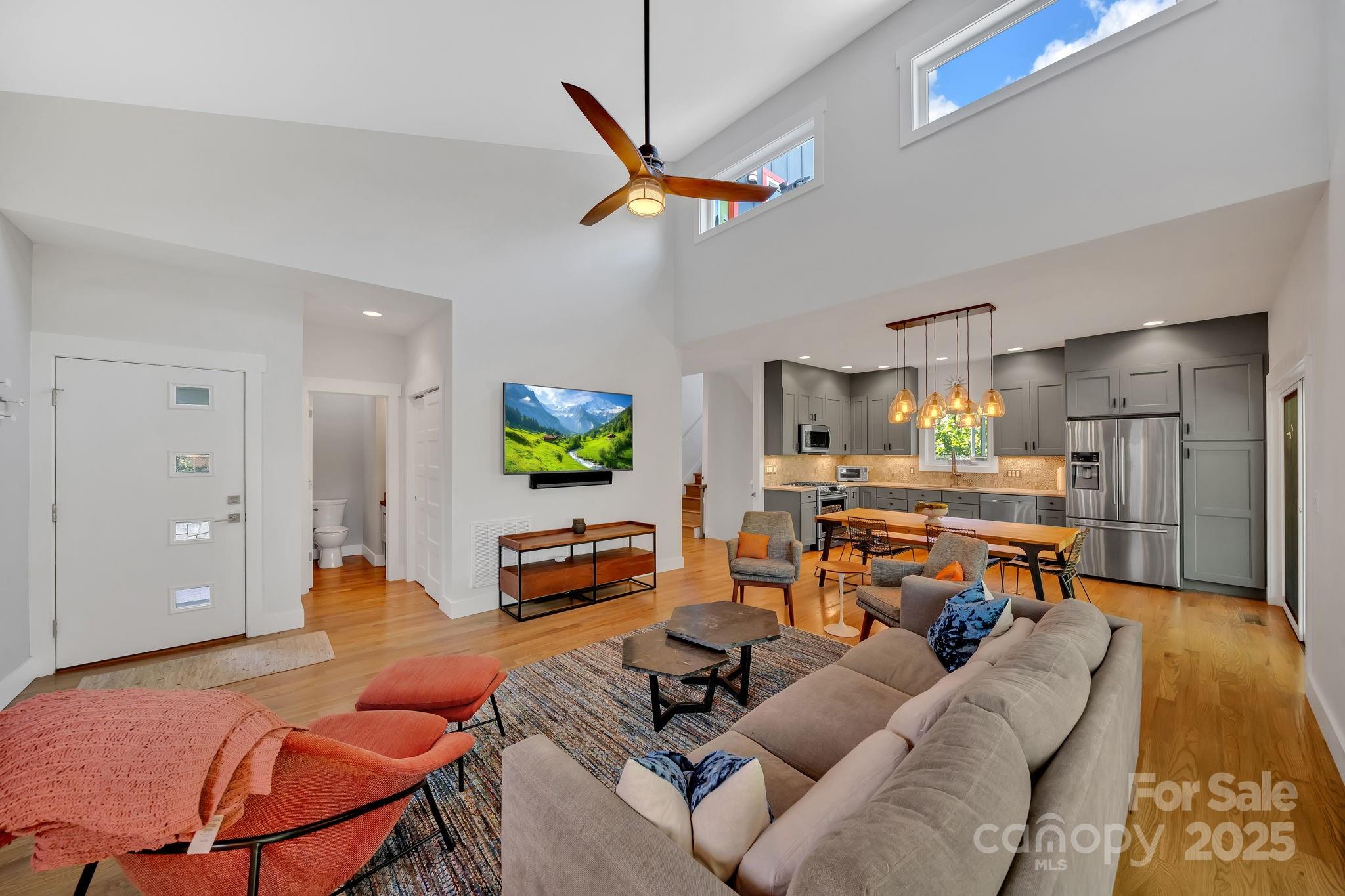 8 Birdhouse Row Asheville, NC 28801 - Photo 17 of 46 a living room with furniture and a flat screen tv