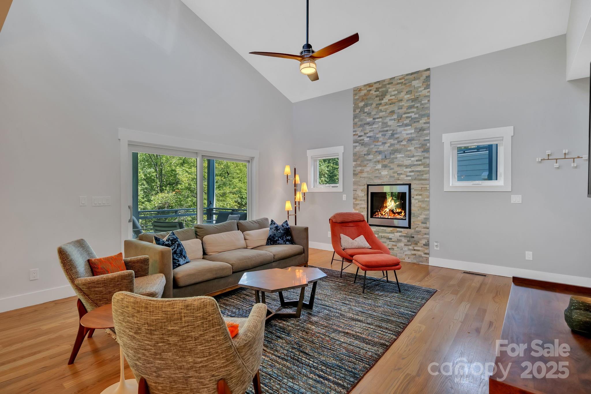 8 Birdhouse Row Asheville, NC 28801 - Photo 18 of 46 a living room with furniture a fireplace and a table