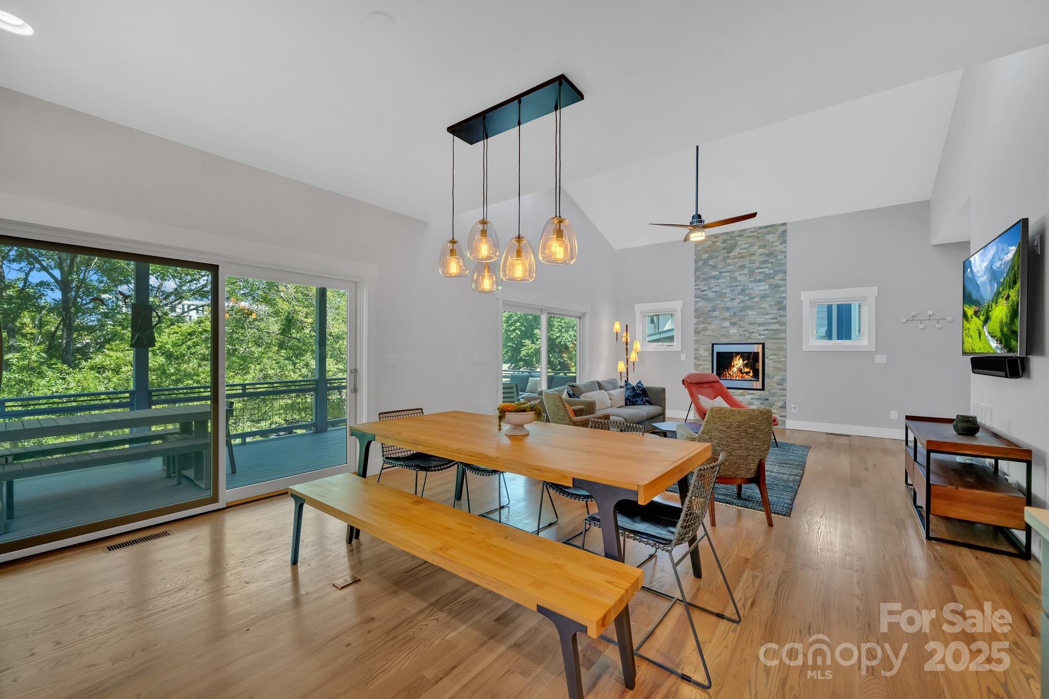 8 Birdhouse Row Asheville, NC 28801 - Photo 21 of 46 a view of a dining room with furniture window and wooden floor