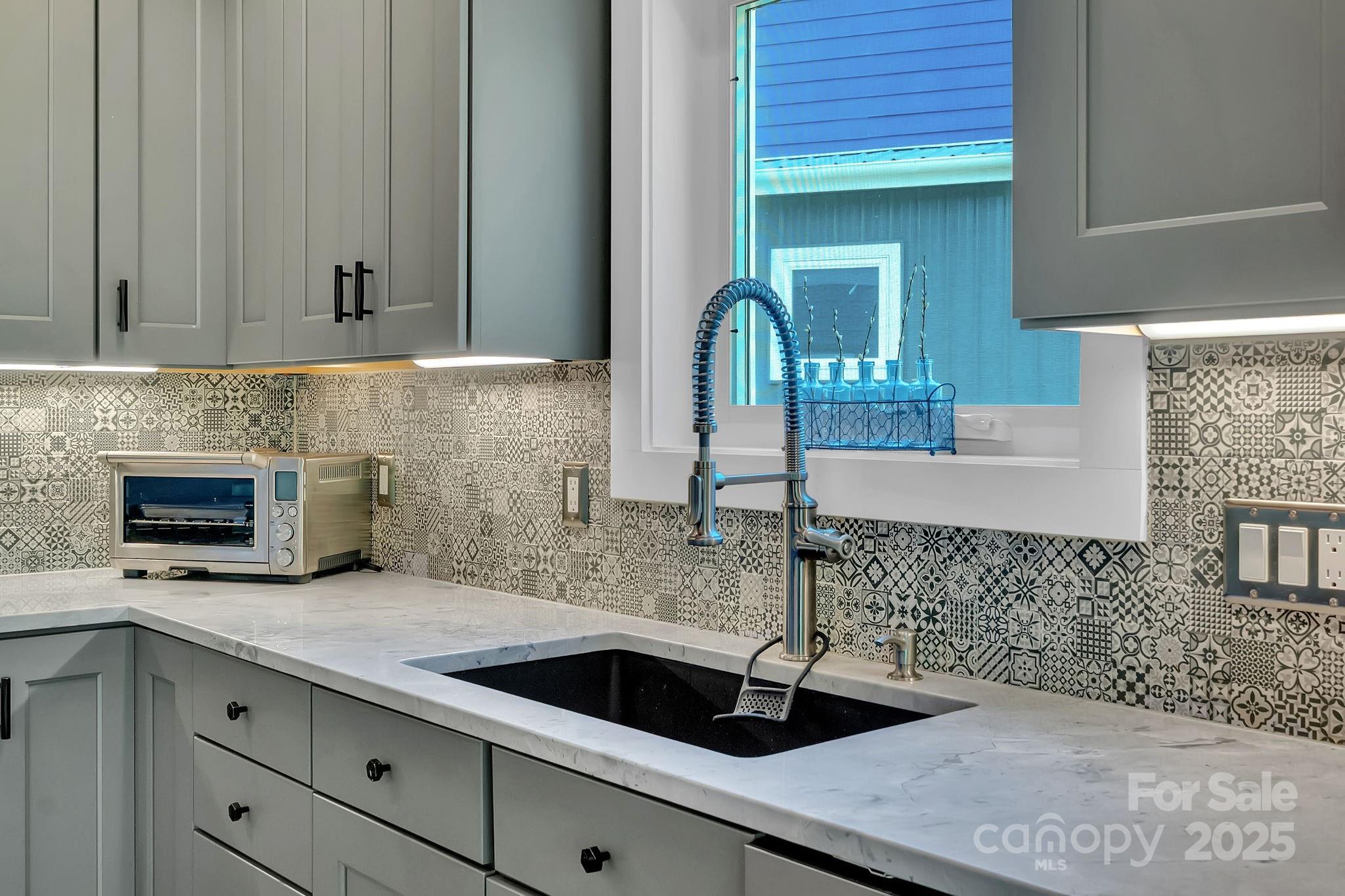 8 Birdhouse Row Asheville, NC 28801 - Photo 23 of 46 a kitchen with a sink and cabinets