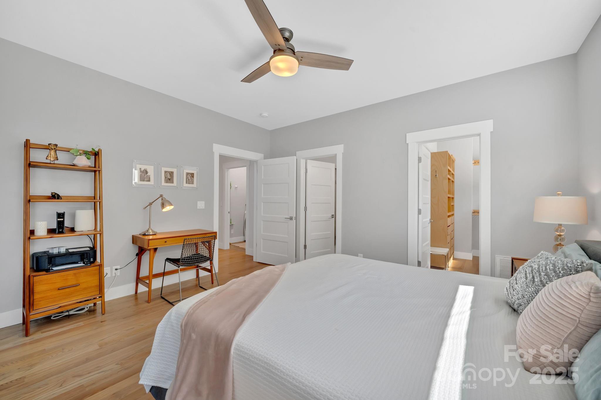 8 Birdhouse Row Asheville, NC 28801 - Photo 29 of 46 a bedroom with a bed and a chandelier