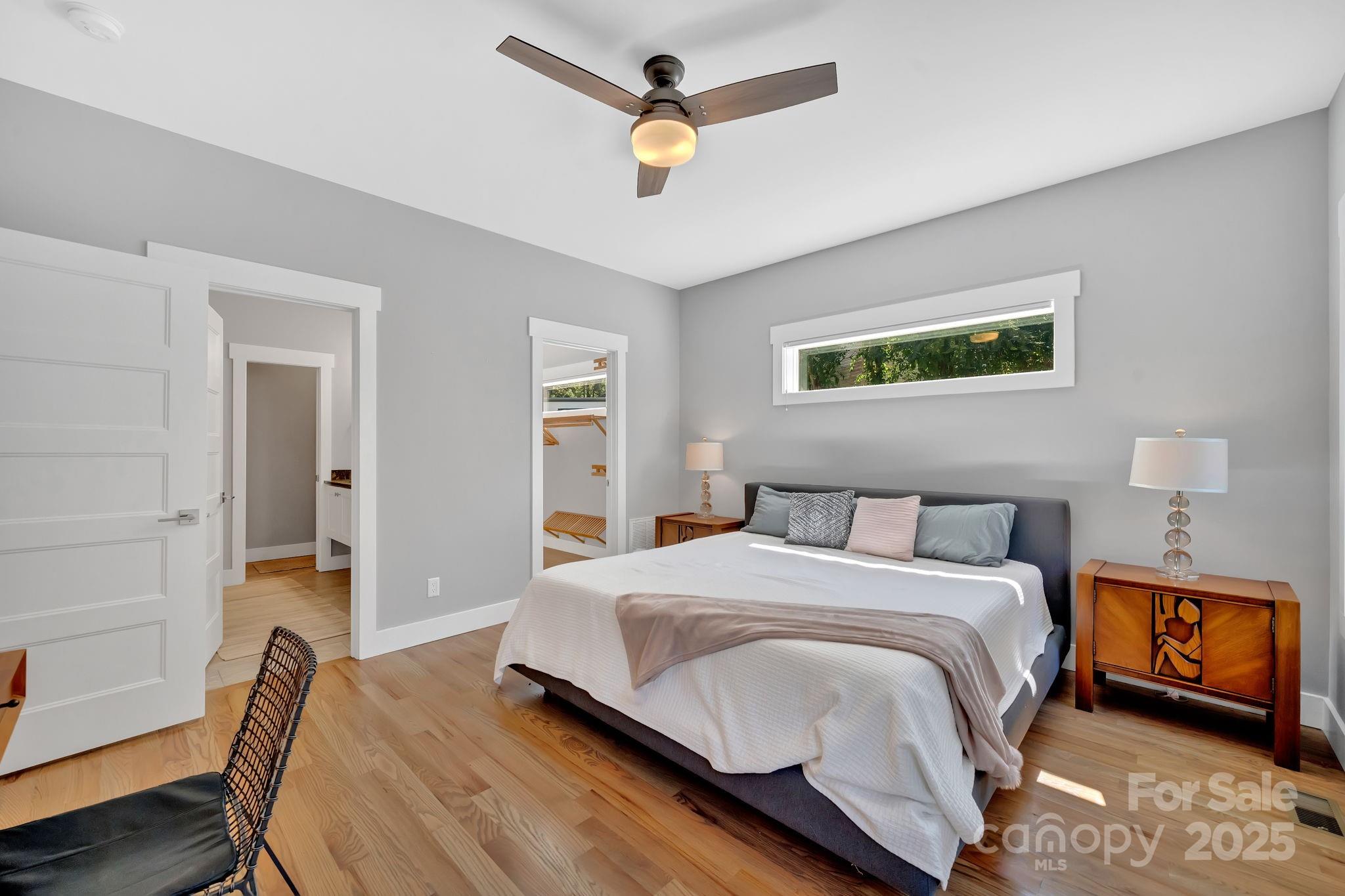8 Birdhouse Row Asheville, NC 28801 - Photo 30 of 46 a bedroom with a bed and wooden floor