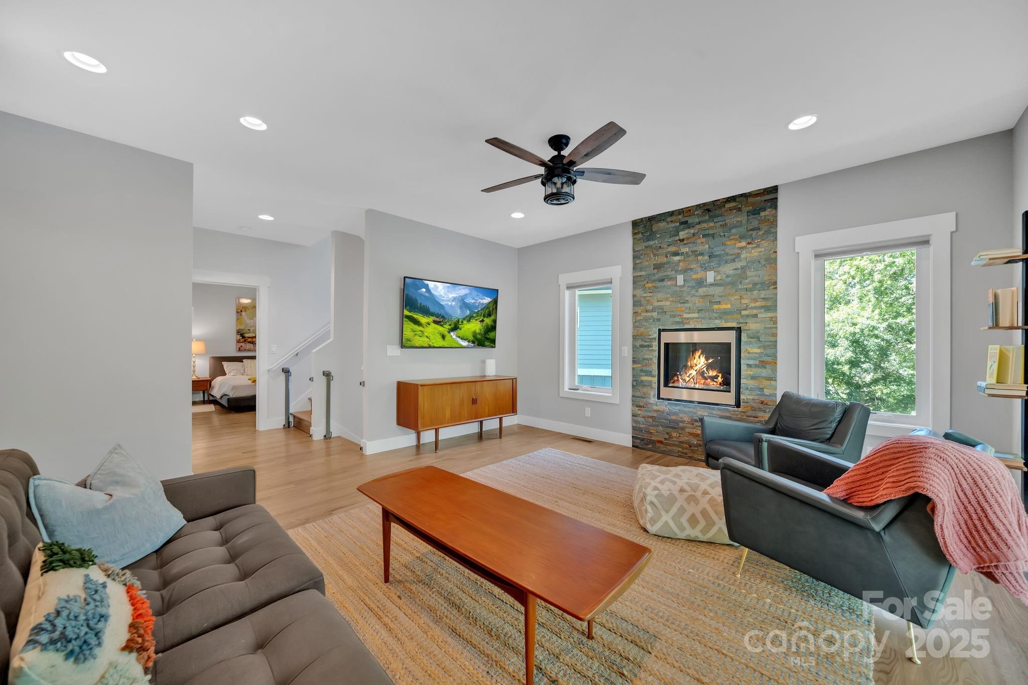 8 Birdhouse Row Asheville, NC 28801 - Photo 34 of 46 a living room with furniture a fireplace and a window