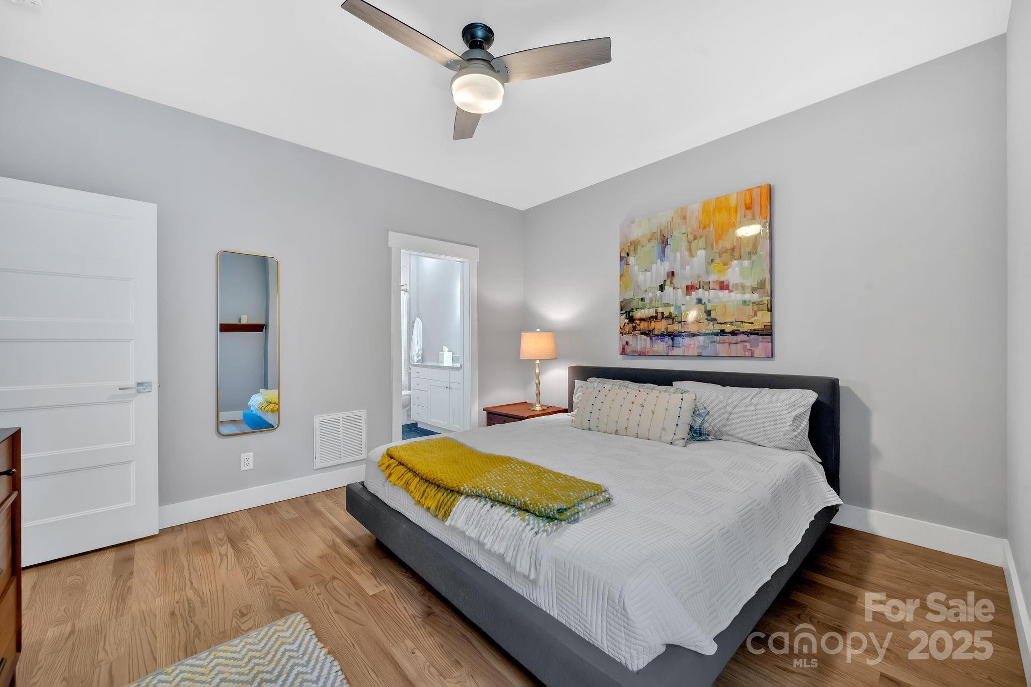 8 Birdhouse Row Asheville, NC 28801 - Photo 36 of 46 a bedroom with a bed and painting on the wall