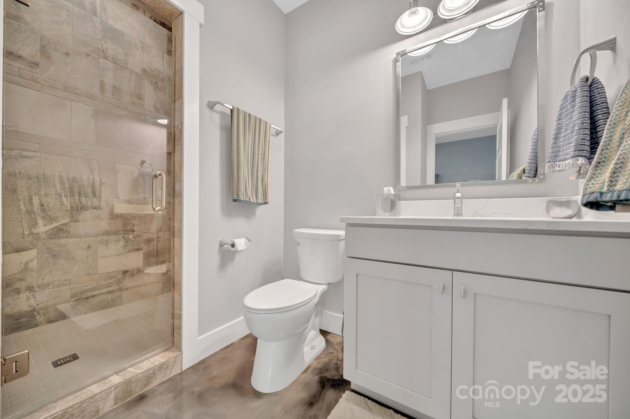 8 Birdhouse Row Asheville, NC 28801 - Photo 37 of 46 a bathroom with a sink toilet and shower