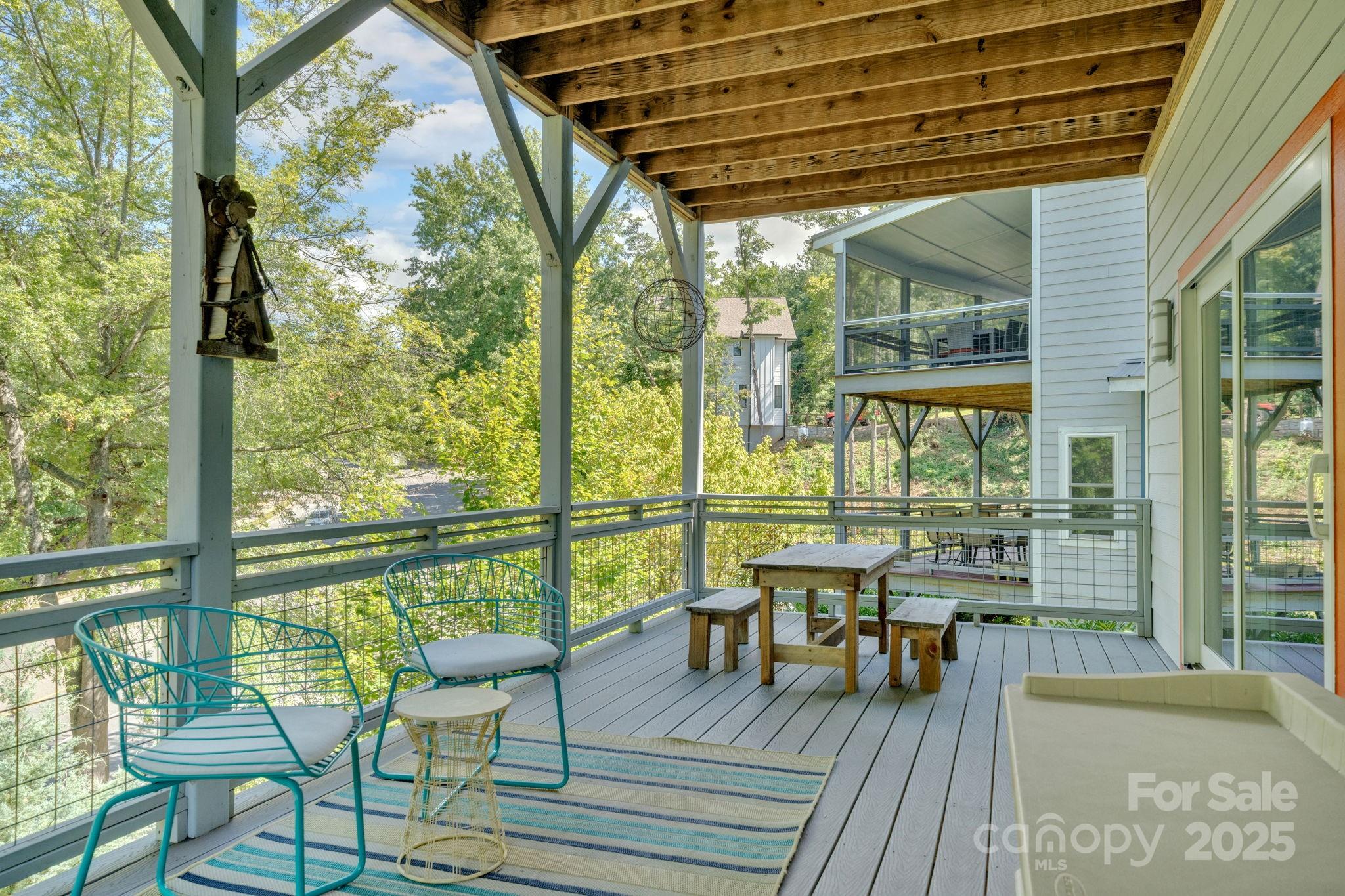 8 Birdhouse Row Asheville, NC 28801 - Photo 40 of 46 a balcony with wooden floor table and chairs
