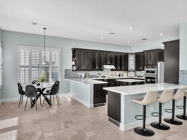 a kitchen with stainless steel appliances a sink stove and cabinets
