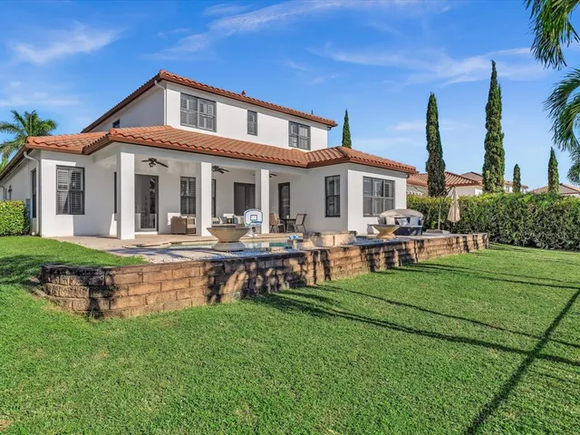 a view of a house with pool and chairs