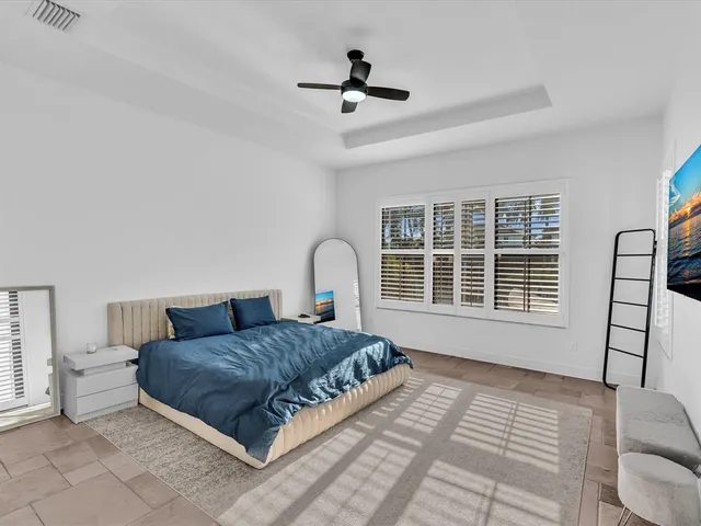 a bedroom with a bed and a flat screen tv