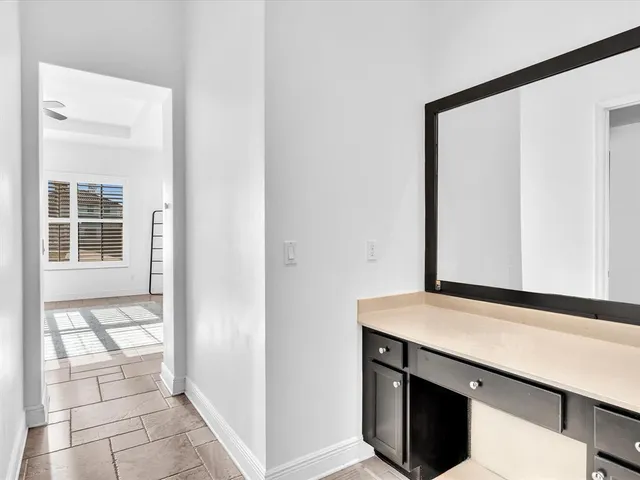 a bathroom with a granite countertop sink a toilet and mirror