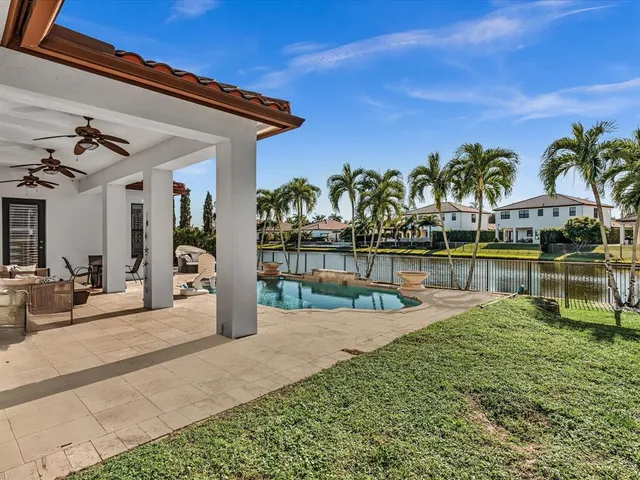 a swimming pool with outdoor seating and yard